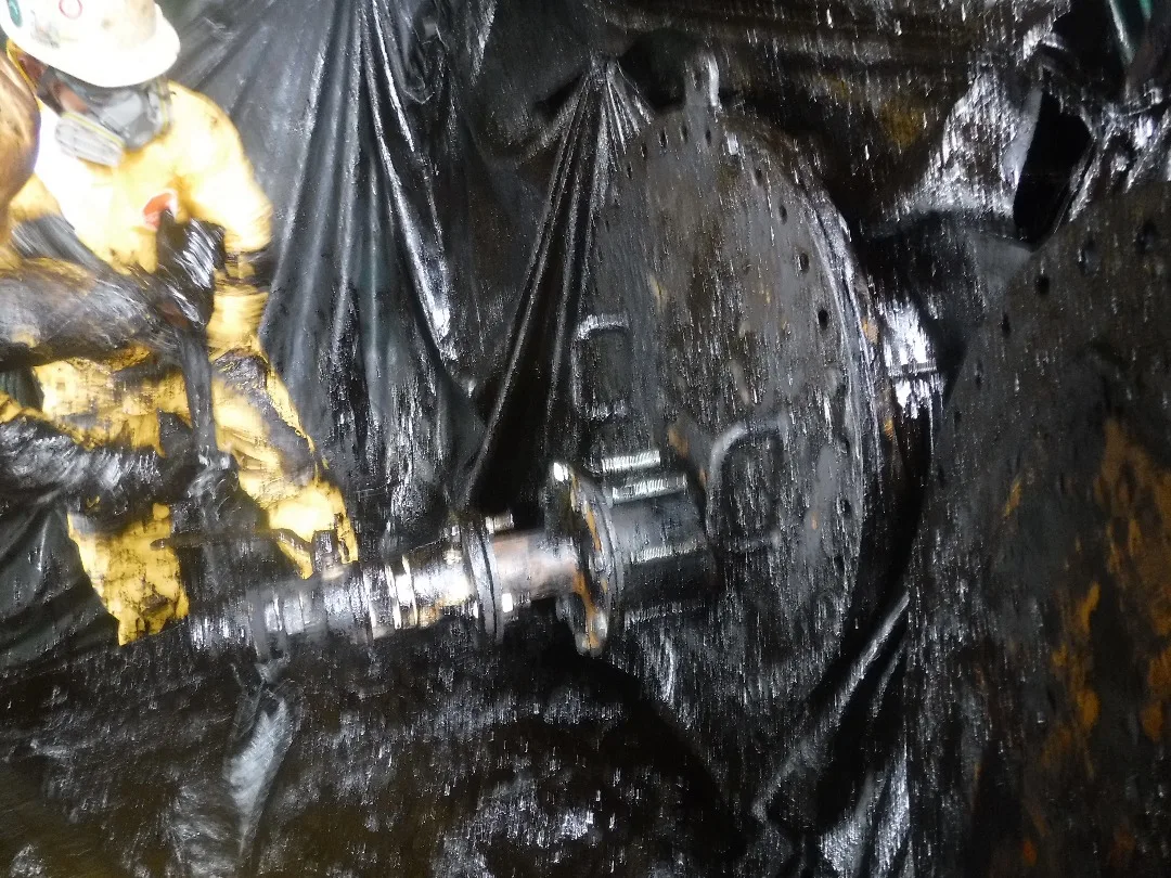 Manual work around thick industrial sludge